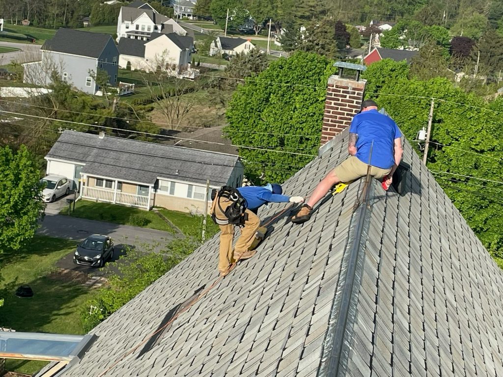 Grace Family Roofing crew performing roof repair work on a residential roof.